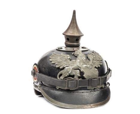 A Baden enlisted mans pickelhaube, with grey steel plate and mounts, national and state cockades, and leather chinstrap and l