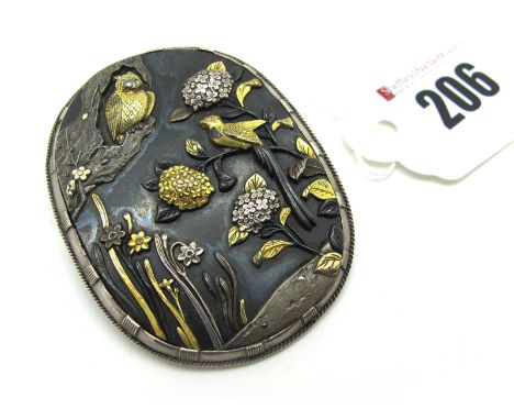 A XIX Century Japanese Shakudo Panel Brooch, of oval form depicting birds and foliage, 5.5 cm long.