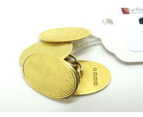 A Pair of 18ct Gold Gent's Cufflinks, the oval panels engine turned, on chain connections.