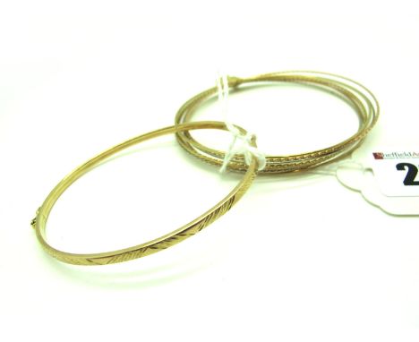 A Modern Bangle, with part textured design, stamped "375", another bangle, of multi alternate tri-colour design, suspending a