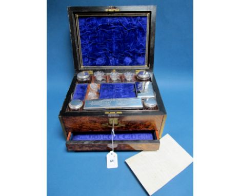 A XIX Century Walnut Travelling Box, the plush lined fitted interior with assorted stoppered glass bottles, jars, plated moun