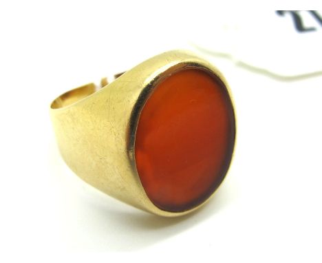 A Gent's Signet Style Ring, with inset oval hardstone panel, within plain setting and shoulders, stamped "750" (finger size S