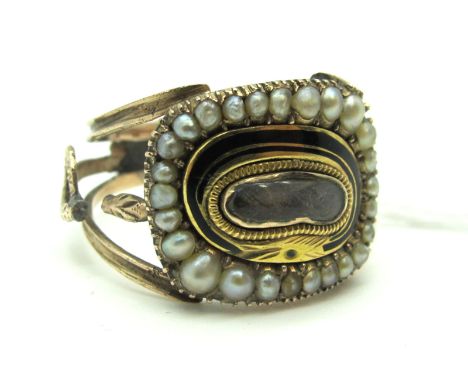 A Pearl and Enamel Mourning Ring, detailed to the centre with a glazed hairwork panel, between openwork shoulders with coiled