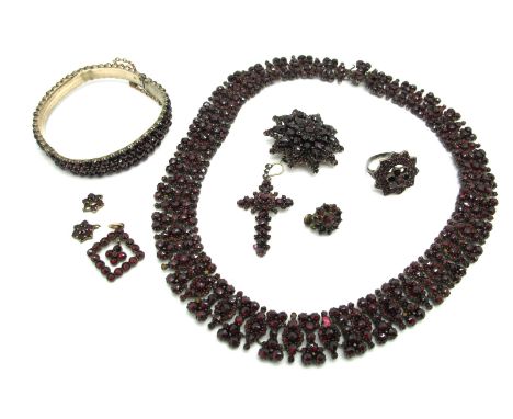 A XIX Century Garnet Set Necklet, of uniform design, set throughout with graduated rose cut stones, to snap clasp, overall le