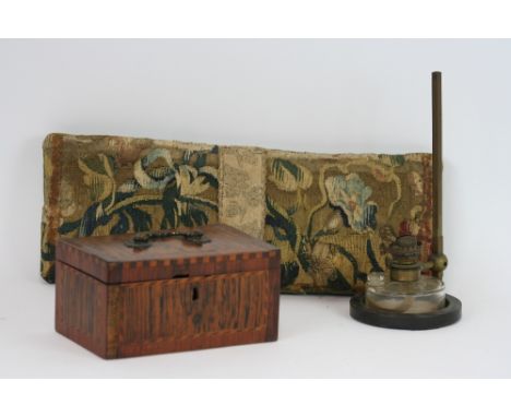 A Georgian inlaid tea caddy,  AF; an antique needlework kneeler cushion; and an unusual rise and fall glass based oil lamp (3