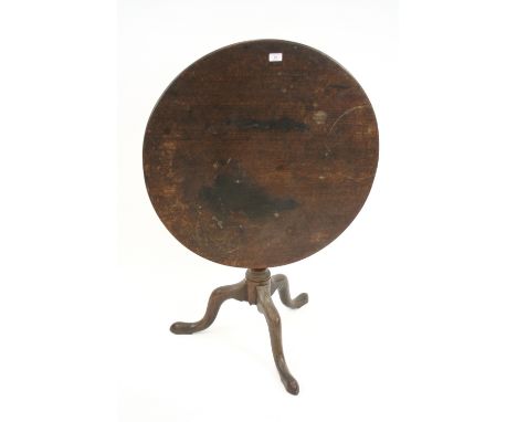 An antique mahogany circular snap top occasional table, raised on a bird cage and turned baluster column terminating in tripo