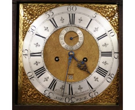 A Georgian oak long case clock, the hood surmounted by a shaped pediment and enclosing a brass spandrel dial with steel chapt