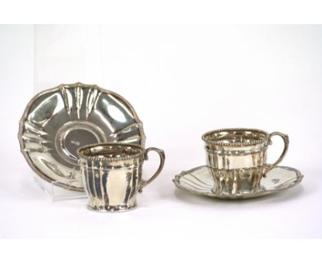 A set of six continental white metal coffee cup holders and saucers, with beaded decoration