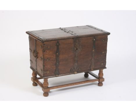 A continental metal bound trunk, the hinged lid inscribed "1846", flanked by side carrying handles and raised on a later turn