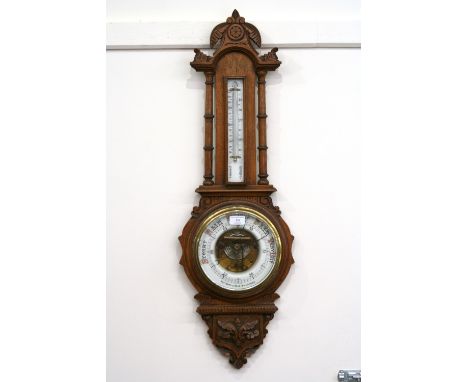 A late Victorian carved oak barometer/thermometer, by Fattorini & Sons, Bradford, 86cm 
