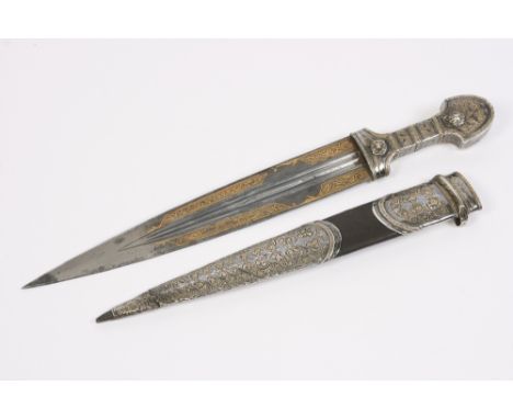 A fine 19th Century Ottoman dagger or Kard, with silvered and Niello ware handle, the steel blade damascened with script, pro