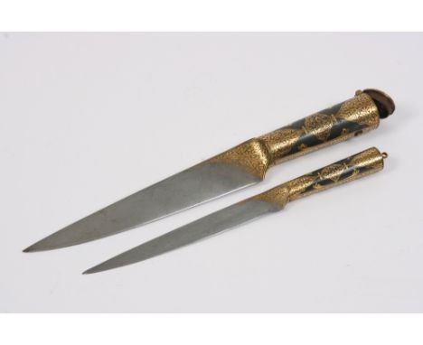 A fine Middle Eastern steel and damascened dagger, the hinged grip concealing a similar but smaller dagger, 31cm x 26cm long 