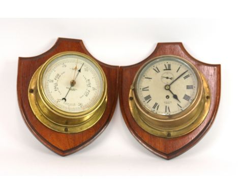 A Smith Empire brass bulk head clock; and a Berry & Mackay of Aberdeen brass bulk head barometer, both mounted on oak shield 