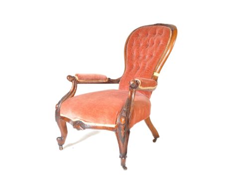 A Victorian 19th century mahogany upholstered spoon back hall ladies chair. The armchair having an upholstered button back, a