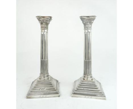 A PAIR OF GEORGE V SILVER CANDLESTICKS by Fattorini &amp; Sons, Birmingham 1923, modelled as Corinthian columns, the shafts f