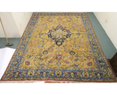 A LARGE MUSTARD GROUND HERIZ RUG with dark blue central medallion, floral pattern ground and light blue flower head border  4