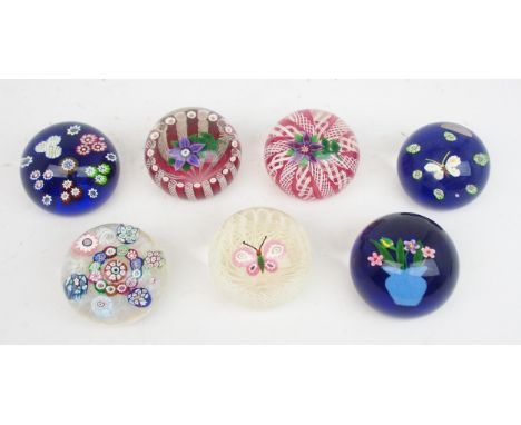 FOUR PAUL YSART HARLAND GLASS PAPERWEIGHTS including a butterfly, a flower on ribbon cane background and two millefiori examp