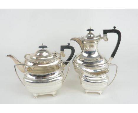 A GEORGE V SILVER FOUR PIECE TEA SERVICE by Walker &amp; Hall, Sheffield 1930, of baluster form, with a gadrooned border, sup
