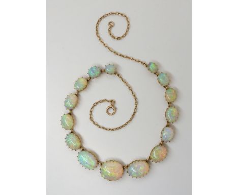 A SUBSTANTIAL OPAL NECKLACE mounted in 15ct gold throughout with delicate multi claw crown settings. The largest opal has the