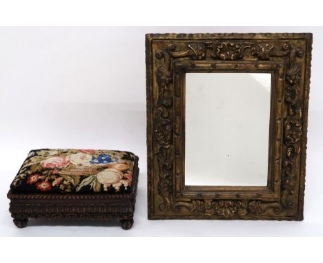 A 19TH CENTURY ANGLO-INDIAN TAPESTRY FOOTSTOOL extensively carved base with gadrooned edge on turned feet, 18cm high x 38cm w