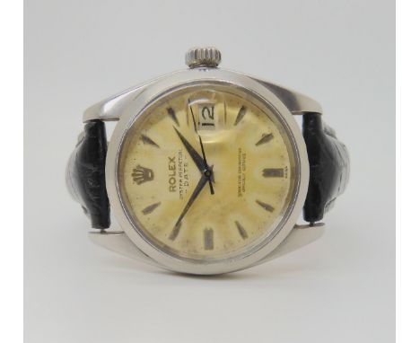 A ROLEX OYSTER PERPETUAL DATE with cream patinaed dial, dagger indexes and date aperture. Diameter of the case 33mm. Numbers 