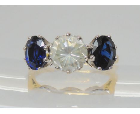 A SUBSTANTIAL SAPPHIRE AND DIAMOND RING set in a 18ct yellow and white gold classic crown setting the central diamond of esti