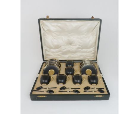 SIX ROYAL WORCESTER DEMITASSE COFFEE CUPS AND SAUCERS boxed, pattern no. C644, the black ground with gilt borders, date mark 