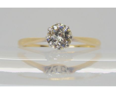 A DIAMOND SOLITAIRE RING set with an estimated approx 0.70cts old cut diamond in a platinum crown mount with an 18ct gold sha