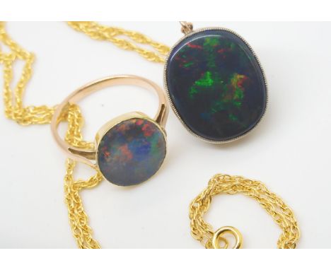 A BLACK OPAL PENDANT WITH SIMILAR RING the pendant mounted in 9ct gold appears to be a solid piece of opal, with matrix to th