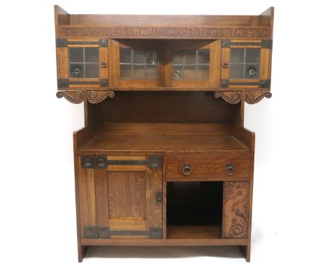 AN EARLY 20TH CENTURY OAK ARTS & CRAFTS SIDEBOARD BY WARINGS FOR WARING G GILLOW LTD  with leaded glass superstructure carved