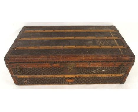 AN E GOYARD PARIS LEATHER AND WOOD BOUND STEAMER TRUNK with all-over printed design, leather edges and wooden ribs held by br