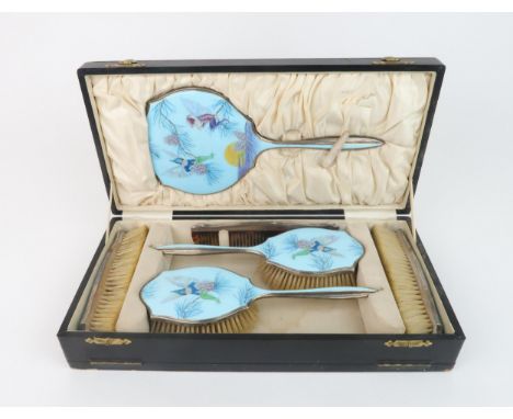 AN ENAMELLED AND SILVER DRESSING TABLE SET with a design after an illustration by Margaret W Tarrant of The Scots Pine Fairie