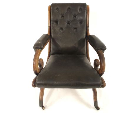 A VICTORIAN ROSEWOOD & GREEN BUTTON BACK LEATHER UPHOLSTERED LIBRARY CHAIR with reclined back over padded scrolled arms on bo