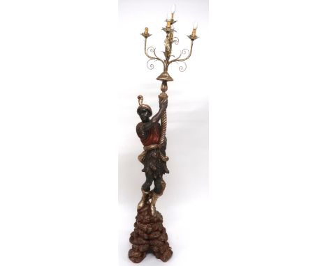 A 20TH CENTURY CARVED WOOD BLACKAMOOR STANDARD LAMP with gilt five branch foliate light mount held by painted blackamoor figu