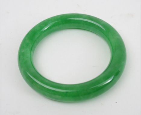 A CHINESE GREEN HARDSTONE BANGLE 8.8cm diameter Condition Report:"6cm inner diameter. Where is the item from? A private clien