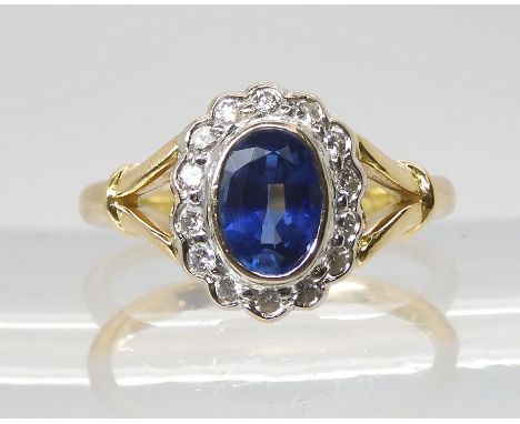 A SAPPHIRE &amp; DIAMOND CLUSTER RING the central sapphire measures approx 7mm x 5mm x 3.4mm, further set with brilliant cut 