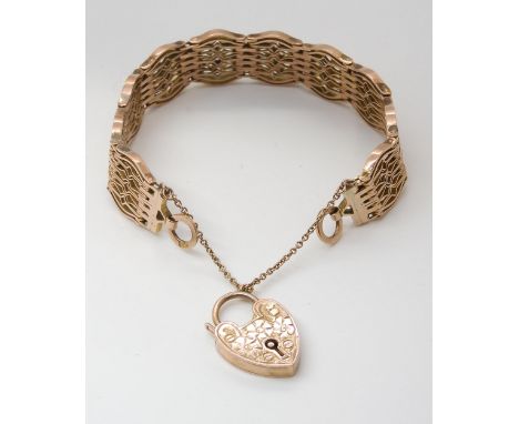 A 9CT GATE BRACELET with an engraved heart shaped clasp, and decorative patterned links, length 18cm, weight 29.5gms Conditio
