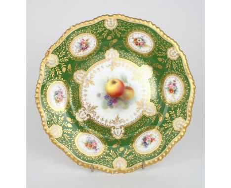 A ROYAL WORCESTER CABINET PLATE painted with a central cartouche of apples and blackberries, surrounded by a deep green band 