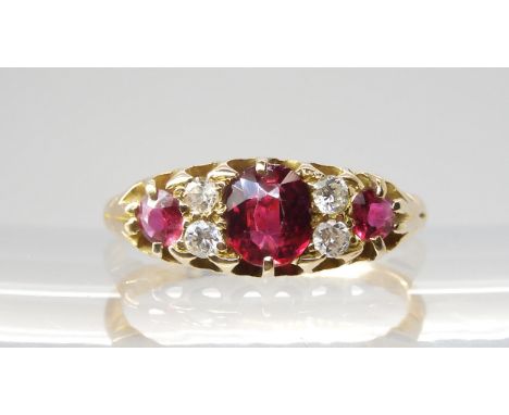 A CLASSIC RUBY & DIAMOND CLUSTER mounted throughout in bright yellow metal (partial hallmarks) the central ruby measures appr