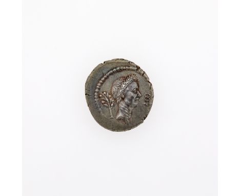 Struck in Rome. OBVERSE: Portrait of Julius Caesar (right), Laurel branch left, winged caduceus right; REVERSE: Charging bull