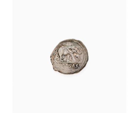 OBVERSE: Elephant (right) trampling serpent with legend CAESAR in exergue; REVERSE: Priestly implements: simpulum, sprinkler,
