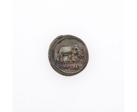OBVERSE: Elephant advancing (right) trampling serpent with legend CAESAR in exergue; REVERSE: Display of priestly implements: