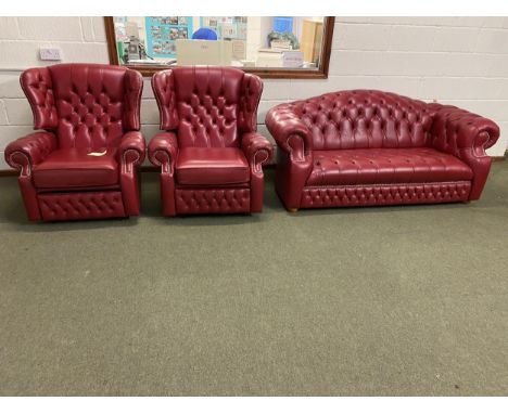 Red leather button back and studd Chesterfield style sofa and pair of reclining chairs  (with fire labels), in good condition