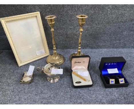 Quantity of items to include, cufflinks, mother of pearl case match holder, and cufflinks , and a pair of brass candlesticks 