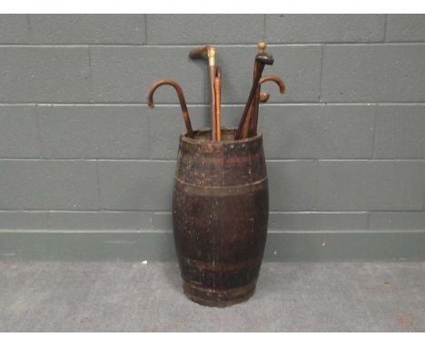 A 19th-century coopered oak barrel/ stick stand, 61 x 31cm; together with a collection of various walking sticks