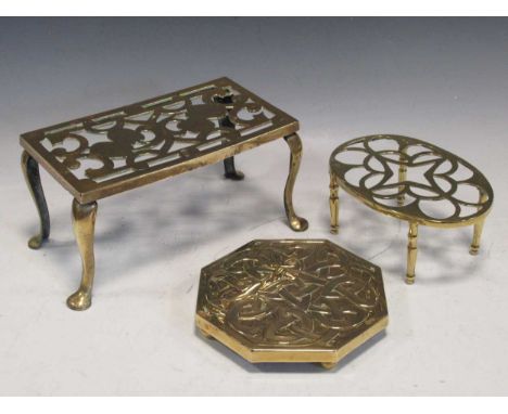 Three brass trivets, to include an octagonal brass trivet with Celtic knot decoration, a rectangular pierced trivet decorated