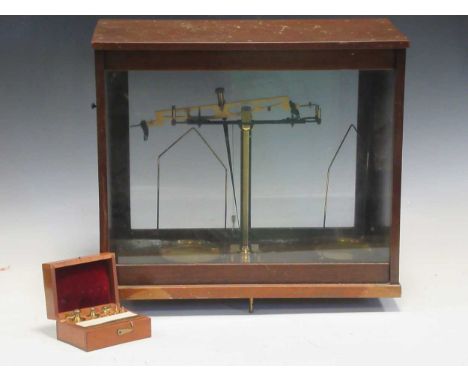 Scales within a glazed case together with weights in a smaller wooden box, 42 x 46 x 24cm