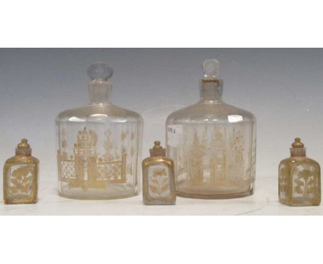 Three small 19th century glass scent bottles with gilt painted floral decoration together with a pair of larger faceted bottl