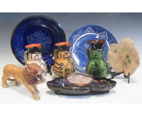 A Wooden model of a lion, a pottery leaf-shaped dish,a blue glazed plate incised with leaves, a studio pottery shaped dish, a