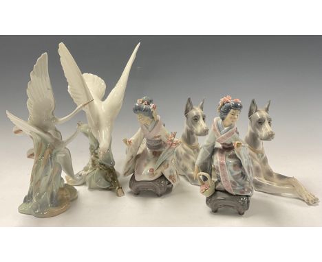 A Lladro model, of a Great Dane, 30.5cm long; another; a Lladro model, of a Dove in flight, 29cm high; a Nao model, of a pair